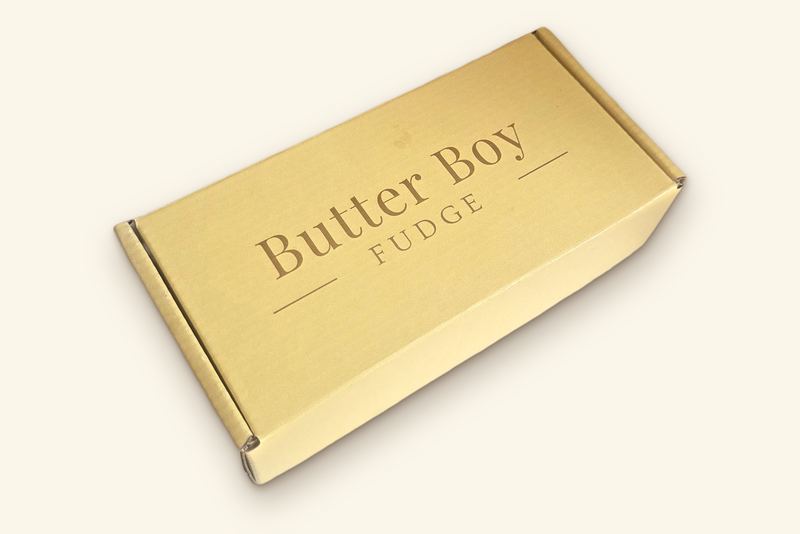 Closed butter-yellow gift box printed with the Butter Boy Fudge wordmark